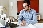 Handsome Young Businessman Working With Laptop In The Office Stock Photo