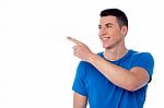 Handsome Young Man Pointing Away Stock Photo