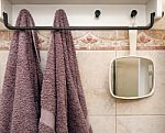 Hanging Objects In The Bathroom: Two Towels And A White Mirror Stock Photo