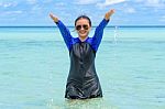 Happy Asian Teen Girl Play Splashing Water In The Sea Stock Photo