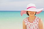 Happy Child Relaxing On The Beach Against Sea And Sky Background Stock Photo