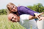 Happy Couple Enjoying With Their Arms Outstreched Stock Photo