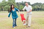 Happy Couple Playing With Their Daughter Stock Photo