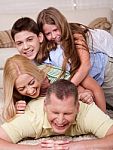 Happy Family Of Four Having Fun In Bed Stock Photo