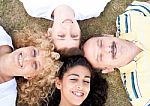 Happy Family Of Four On Grass Stock Photo