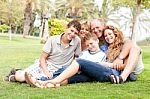 Happy Family Relaxing In The Park Stock Photo