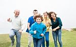Happy Family Running On A Green Meadow Stock Photo