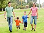 Happy Family Walking In The Park Stock Photo