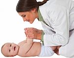Happy Female Pediatrician Playing With Toddler Stock Photo