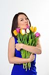 Happy Girl Hugging Fresh Tulips Stock Photo