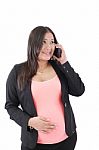 Happy Hispanic Pregnant Woman Talks At Cell Phone Stock Photo