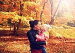 Happy Kissing Mother And Daughter In Autumn Park Stock Photo