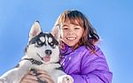 Happy Little Girl Holding Her Puppy Dog Husky Stock Photo