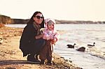 Happy Mother With Her Daughter On The Seaside In Spring Stock Photo