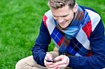 Happy Smiling Man Using Mobile Phone On Park Stock Photo