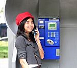 Happy Woman Calling From Public Phone Stock Photo