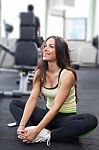 Happy Woman Having A Break From Exercising In Health Club Stock Photo
