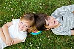 Happy Young Brothers Lying On Grass Stock Photo