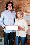 Happy Young Couple Holding Pizza Boxes Stock Photo