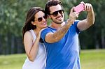 Happy Young Couple Taking Selfies With Her Smartphone In The Par Stock Photo