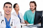 Happy Young Doctor In Focus, Two Others In Out Of Focus Stock Photo