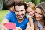 Happy Young Family Taking Selfies With Her Smartphone In The Par Stock Photo