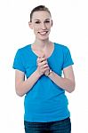 Happy Young Girl With Clasped Hands Stock Photo