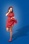Happy Young Pinup Standing Woman Talking On Phone Stock Photo