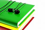 Headphones And Stack Of Multicolored Books On A White Background Stock Photo