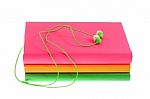 Headphones And Stack Of Multicolored Books On A White Background Stock Photo
