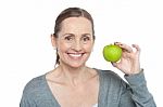 Health Conscious Woman Holding Fresh Green Apple Stock Photo