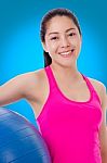 Healthy Woman - Girl Smiling And Holding Fitness Ball, Blue Back Stock Photo