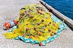 Heap Of Yellow Fishnet On Ground At Sea Stock Photo