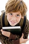 High Angle View Of Smiling School Boy Looking At Camera Stock Photo