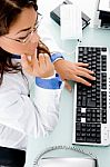 High Angle View Of Working Adult Female Doctor Stock Photo