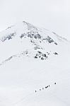 Hikers Climbing A Snow Mountain Stock Photo