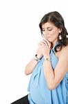 Hispanic Pregnant Woman Praying With Hands Together Stock Photo
