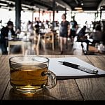Hot Tea With Notebook And Pen On Wooden Table Stock Photo