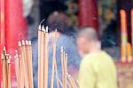 Incense Stick Burning Slowly With Fragrant Smell Smoke. People Praying On Chinese Buddhist Temple On Chinese New Year, Luna New Year Stock Photo