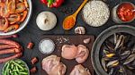 Ingredients For Paella On The Dark Stone Table Top View Stock Photo