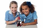 Joyous Young School Girls With Microscope Stock Photo