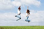 Jumping Joyful Couple Stock Photo