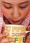 Keeping Snug And Warm With Coffee Stock Photo