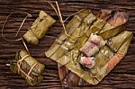 Khao Tom Mat - Thai Dessert - Sticky Rice, Banana And Black Beans Wrapped In Banana Leaf Stock Photo