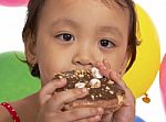 Kid Eating Donut At Party Stock Photo