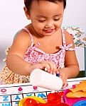Kid Playing At Pouring Cup Of Tea Stock Photo