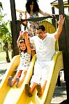 Kid Riding On Swing With Her Dad Stock Photo