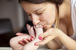 Kissing Baby Feet Stock Photo