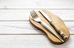 Knife And Fork On Wooden Background Stock Photo