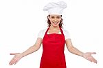 Lady chef showing welcome gesture Stock Photo